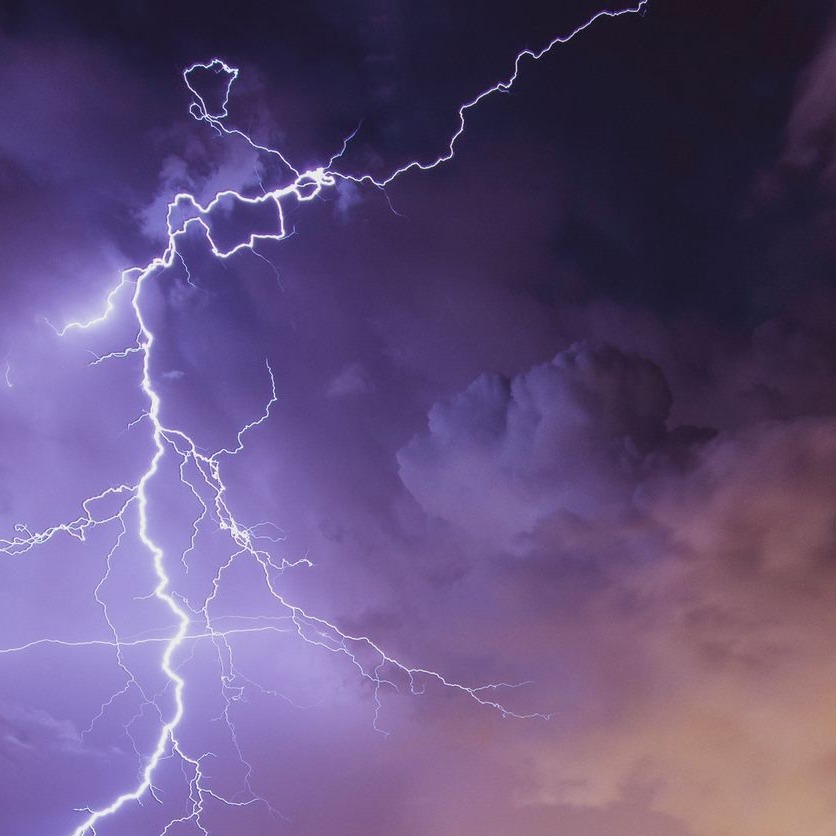 Cover art for The Devil's Worst Nightmare: a violet lightning bolt splitting dark storm clouds