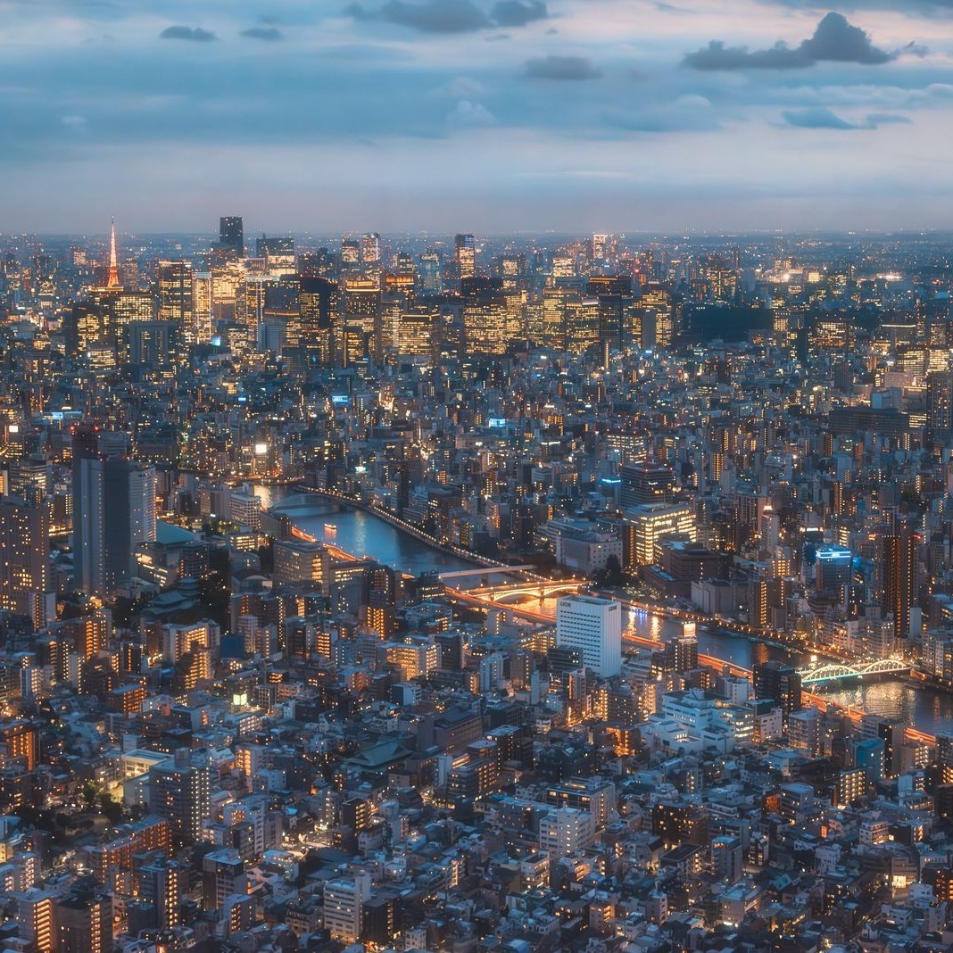 Cover art for High Status: a glowing city at dusk seen from above